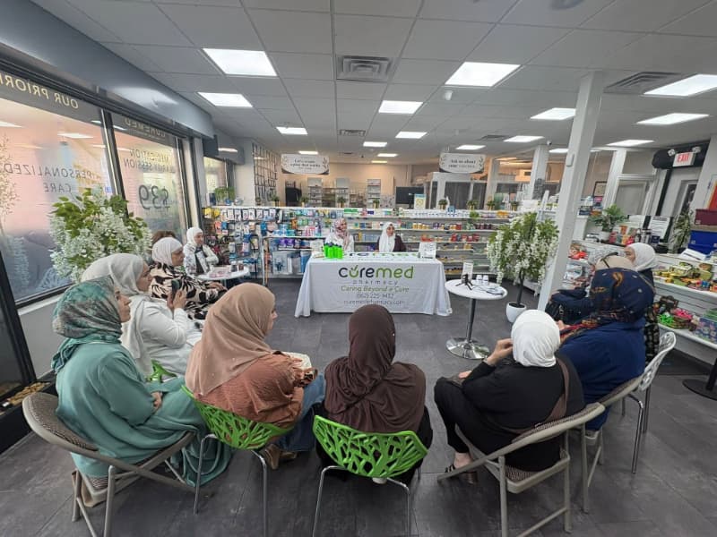 Dr. Ghada AbuKuwaik leading a community health session at CureMed Pharmacy